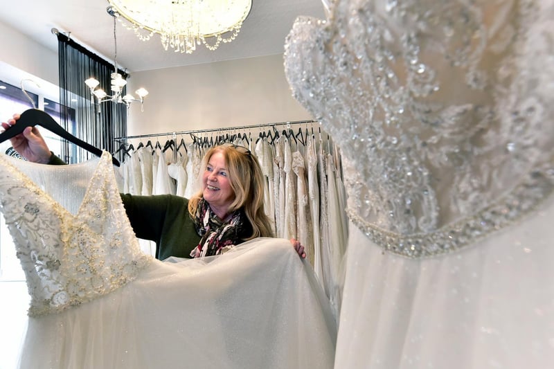 Cathryn Baker of The Wedding Room prepares her dresses for customers.