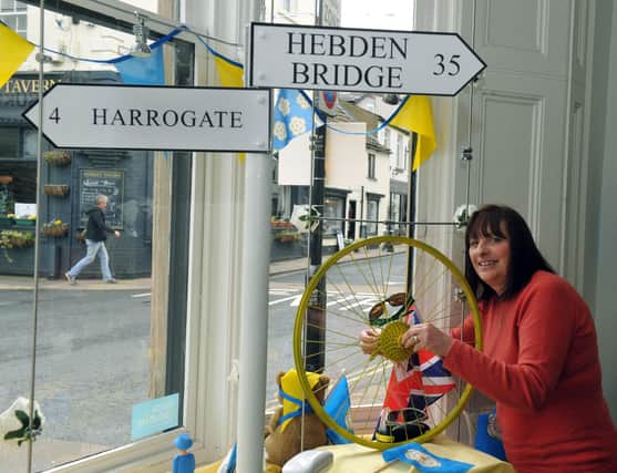 290416     Carole Ratcliffe Receptionist at  Samanatha Parker Opticians  in Knaresborough getting the window display ready as the town gears up for the arrival of stage one of the Tour De Yorkshire (GL1009/86f)