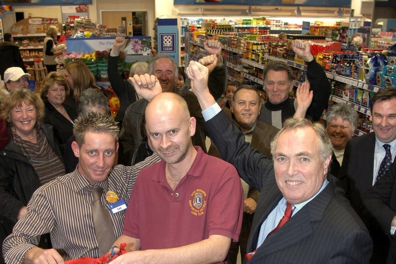Garforth Lions Vice President Dave Richards opens the new Co-op store at Garforth watched by store manager Lee Catling (left), chief executive Alan Gill (right) with staff and customers.