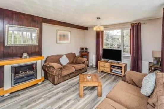 Spacious living room with feature fire place and electric fire. With dual aspect window x 3 ( one of them been a large bay window) over looking the rear and front of the property. There living room also has laminated flooring and 2 x central heating radiator.
