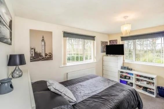 Double bedroom with dual aspect window over looking to side and rear garden and central heating radiator.