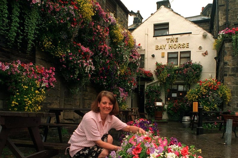 Barmaid LoInda Brown attends to flowers at The Bay Horse in Otley. The pub had been praised in the Britain in Bloom contest.