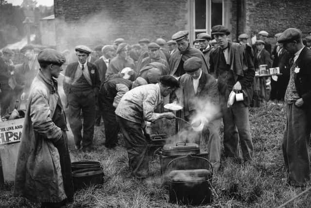 The Jarrow Marchers, walking to London to demand the right to work, line up for corned-beef and potatoes. (Photo by David Savill/Topical Press Agency/Getty Images)