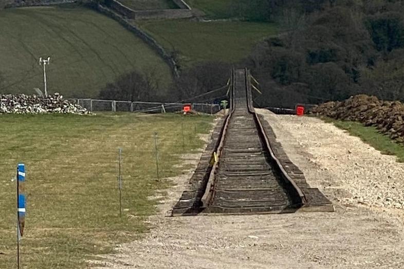 A 370-metre section of railway track leads down to the quarry edge.