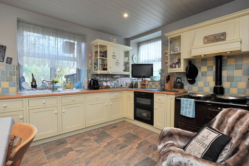 The welcoming kitchen includes an Aga and cream units