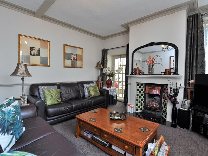 A period fireplace is a focal point of this ground floor room