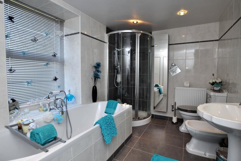 White suite within this modern bathroom that also has a shower cubicle