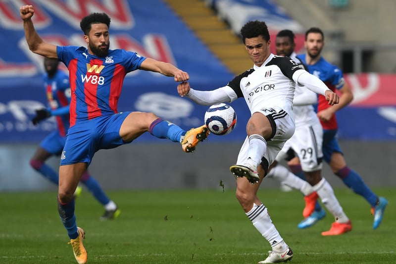 Andros Townsend of Crystal Palace battles for possession with Antonee Robinson of Fulham during the Premier League match between Crystal Palace and Fulham at Selhurst Park on February 28, 2021 in London, England.