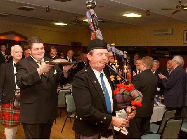 The haggis being piped in at The Grampian's 2003 Burns Night. Pictured are Ian McLean, clue steward Ali McLeod and piper Michael Murray