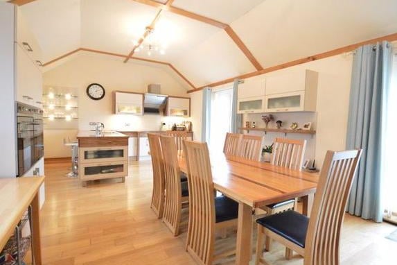 The generously sized kitchen/dining room with lots of natural light