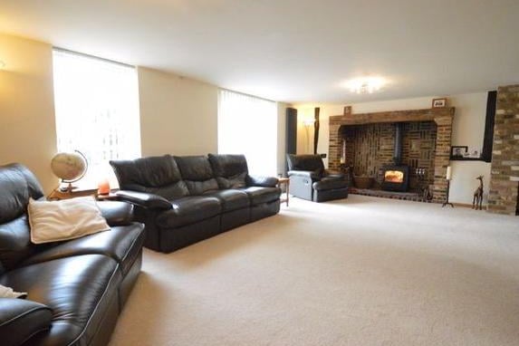 The large sitting room also with a fitted fireplace