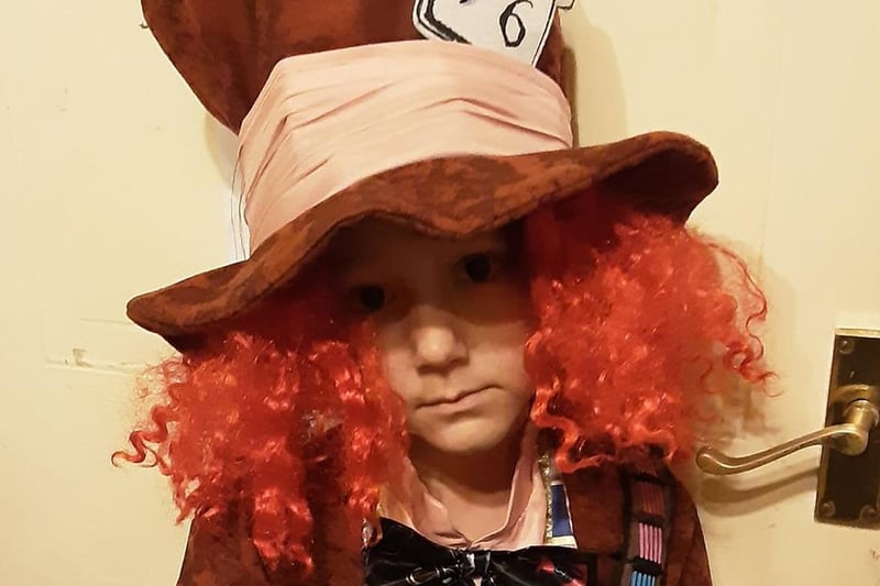 Michael has gone to great efforts to resemble the Mad Hatter from Alice in Wonderland, with a curly orange wig and trademark top hat.