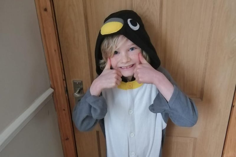 Ellis has become a penguin for the day, inspired by characters from The Emperor's Egg books.