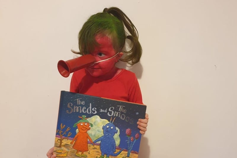 Maisy has dressed up as a young, red smed known to book fans as Janet.