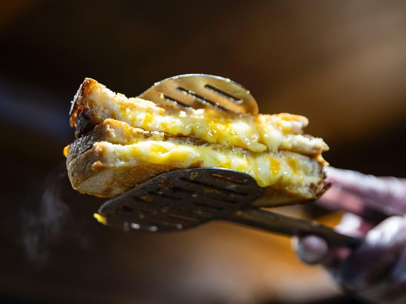 Good Times Café griddled gourmet cheese toasties for customers. Photo: Kirsty Edmonds.