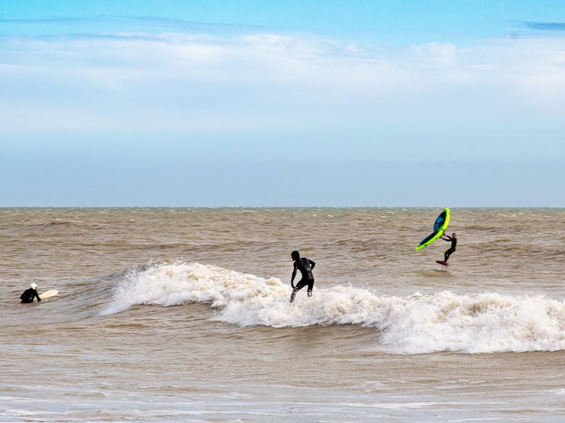 Surfers braving windy conditions at the Wish Tower beach. Taken by Barry Davis with a a Canon 5d mark iii. SUS-210317-101312001
