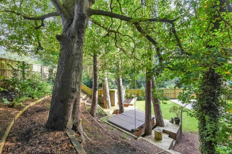 Outside, the property is surrounded by trees.