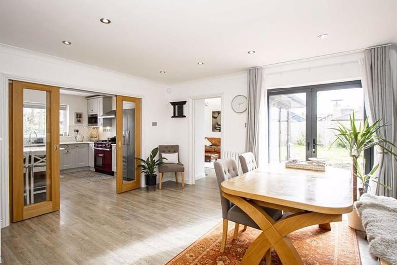 The dining room contains a door to the dinner hallway. It contains a skimmed ceiling with inset lighting. Replacement double glazed doors lead to the rear garden and  open to the living room. Sliding doors to kitchen, stairs to first floor and wood effect flooring are also features of the room.
