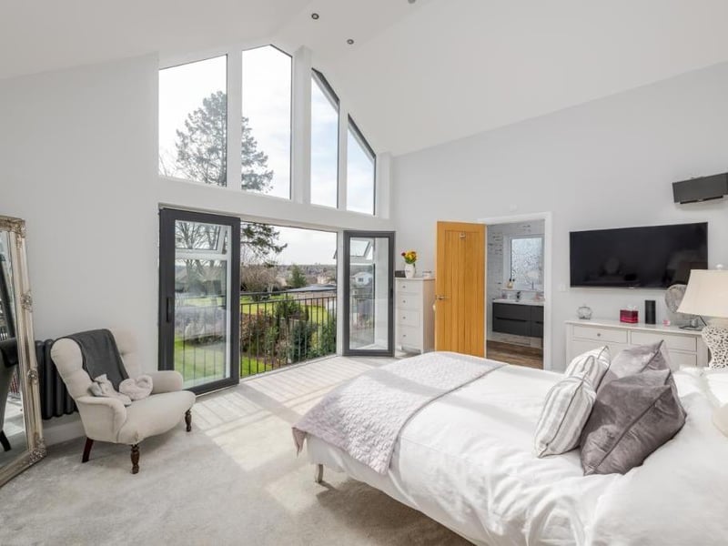 The bedroom features a Juliet balcony