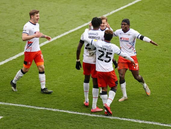 Luton's players celebrate with Elijah Adebayo after the forward made it 3-1 on Saturday