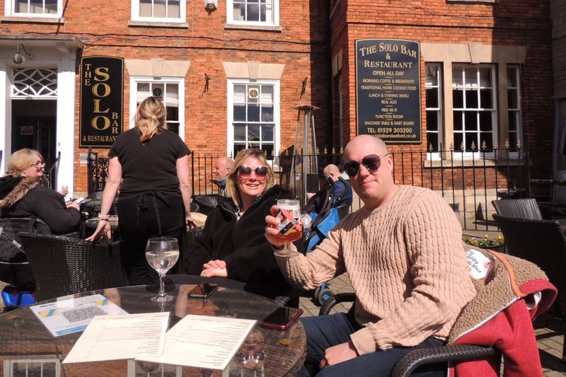 Kyla and Mark Roberts raise a glass at the Solo Bar and Restaurant in Sleaford Market Place. EMN-211204-163439001