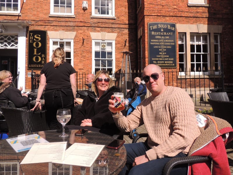 Kyla and Mark Roberts raise a glass at the Solo Bar and Restaurant in Sleaford Market Place. EMN-211204-163439001