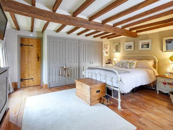 This stone built detached period home complete with  exposed timbers and floor boards has come on the market in the village of Thorpe Mandeville near Banbury (Image from Rightmove)