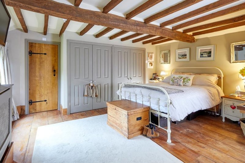 A bedroom inside the period home on the market in Thorpe Mandeville (Image from Rightmove)