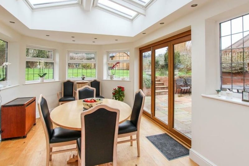 This conservatory boasts skylights and enough space to dine and entertain