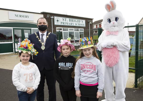 Mayor Brian Tierney with the Easter Bunny prize winner Hannah Browse (centre) a pupil at St. Brigid's PS. Also included are Year 4 class Easter bonnet winners Grace Campbell and, on right, Jenna McShane. ?