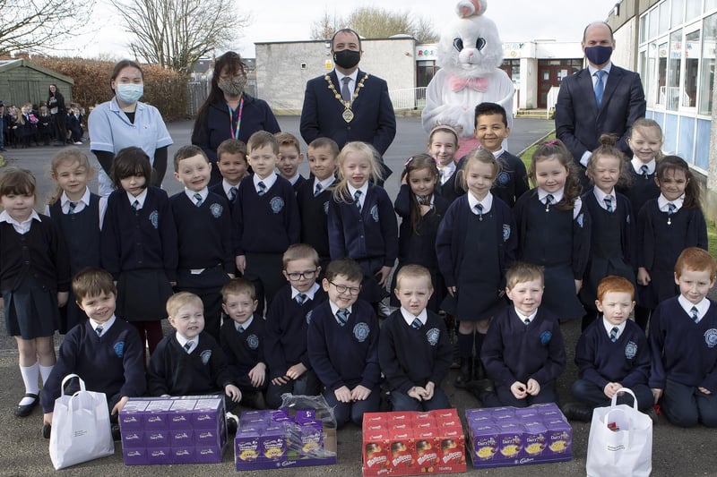 Mayor Brian Tierney with the Easter Bunny on a visit to Rosemount PS with P2 pupils and staff. Included, on right, is Paul Bradley, principal.