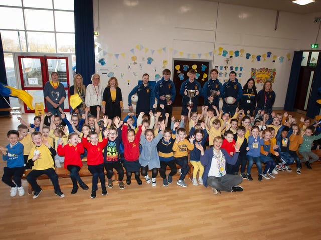 Primary 2 children and staff at Steelstown Primary Schoolcheer on their All-Ireland heroes last week. (Photo: Jim McCafferty)