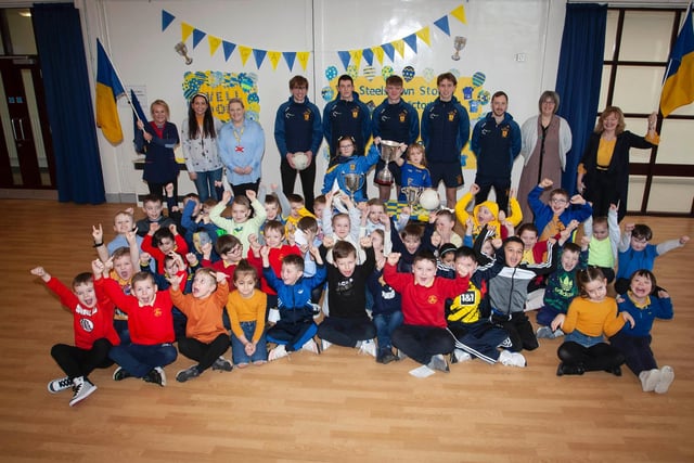 Primary 3 children and staff are overjoyed to meet members of  the All Ireland winning Steelstown Brian Ogs panel last week. (Photo: Jim McCafferty)