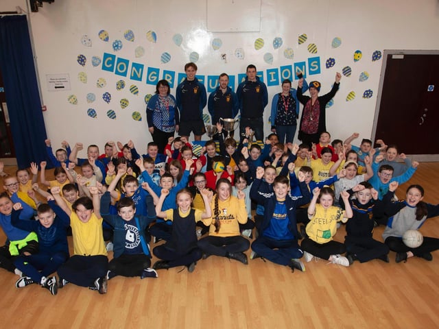 Steelstown Primary School Primary 6 boys and girls cheer members of the Brian Ogs All Ireland winning squad. (Photo: Jim McCafferty)
