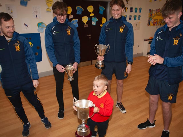 A proud young Joshua is in awe of the weight of the Kieran O'Sullivan Cup on Friday. (Photo: Jim McCafferty)