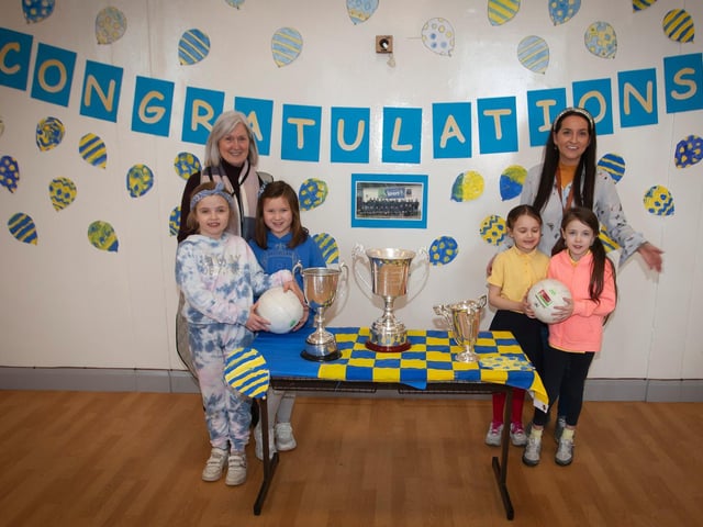 Some of the Primary 3 girls admiring the Derry, Ulster and All Ireland Championship winning trophies with Miss Lynch and Mrs Hutton at Steelstown Primary School. (Photo: Jim McCafferty)