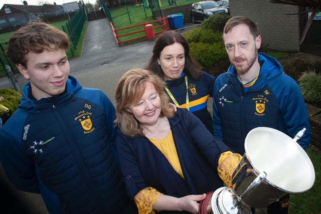 Steelstown P.S. Principal, Mrs. Siobhan Gillen, admiring the Kieran O'Sullivan Cup as Donncha Gilmore, Mrs Gilmore, classroom assistant as well as Donncha's mum, and Neil Forester look on. (Photo: Jim McCafferty)