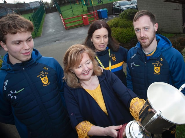 Steelstown P.S. Principal, Mrs. Siobhan Gillen, admiring the Kieran O'Sullivan Cup as Donncha Gilmore, Mrs Gilmore, classroom assistant as well as Donncha's mum, and Neil Forester look on. (Photo: Jim McCafferty)