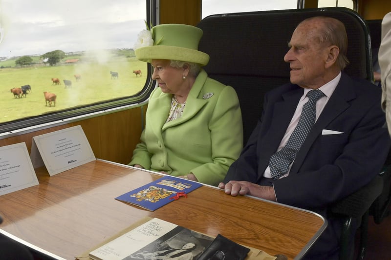 COLERAINE, NORTHERN IRELAND - JUNE 28: Queen Elizabeth II and Prince Philip, Duke Of Edinburgh travel on a steam train from Coleraine Railway Station to Bellarena Station village on June 28, 2016 near Coleraine, Northern Ireland, United Kingdom. The Queen and The Duke of Edinburgh unveiled a plaque to mark the opening of the Bellarena Railway Station before they departed Northern Ireland. (Photo by Arthur Edwards/WPA Pool/Getty Images)