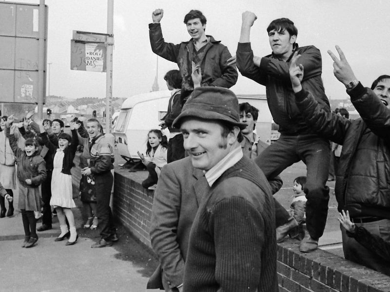March... Travellers living at a car park on Foyle Road make defiant gestures to Department of the Environment officials after they unsuccessfully tried to remove them from the riverfront site.