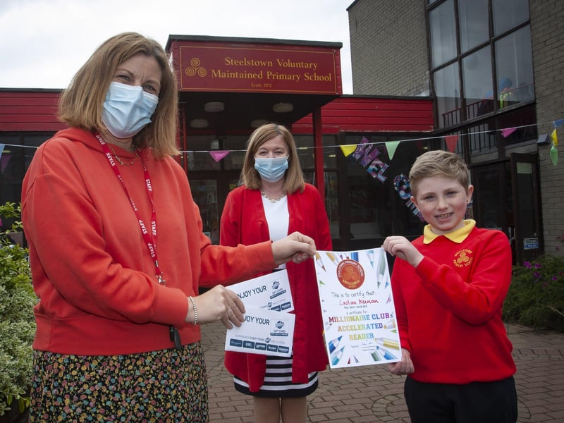 MILLIONAIRE CLUB. . . . .Caolan Keenan (P6b) pictured at Steelstown Primary School this week after joining the Millionaire Club Accelerated Reading. Caolan has now reached 1,540,924 and still climbing. Presenting him with his gift and certificate is Mrs. Victoria Oâ€TMNeill, Literacy Co-Ordinator and centre back, Mrs. Siobhan Gillen, Principal. (Photos: Jim McCafferty Photography)