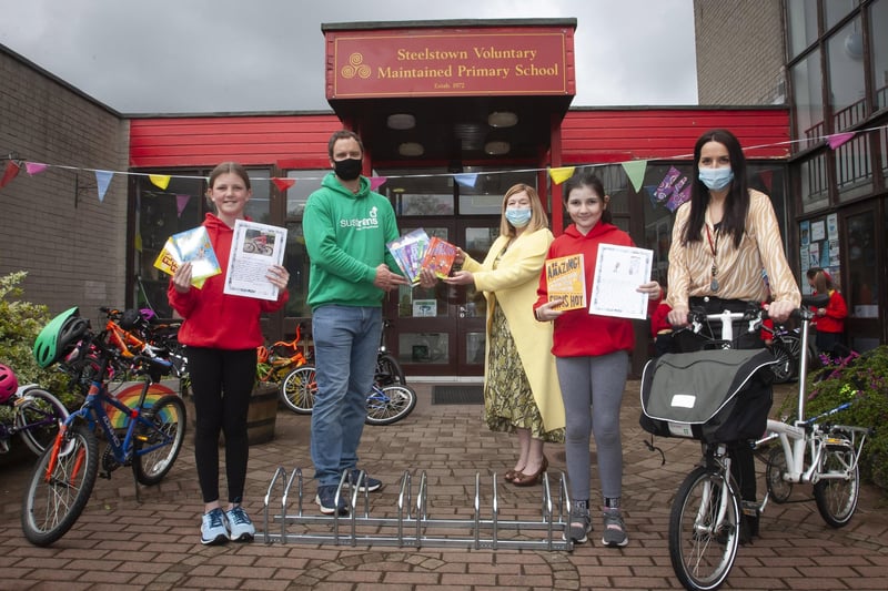 Steelstown PS pupils Lily Harkin and Sophie Harkin who picked up the Sustrans â€ ̃Creative Writingâ€TM Award. Presenting the award to Steelstown Principal, Mrs Siobhan Gillen, is Sustrans Active School Travel Officer, Richard Farrow. Included is World Around Us/Eco Coordinator, Miss Bronagh Lynch.