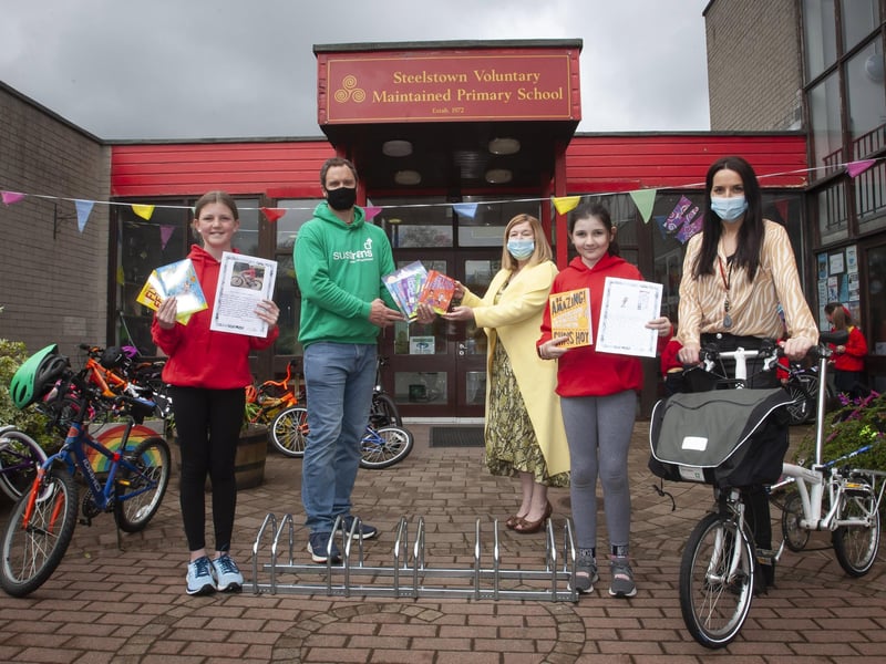 Steelstown PS pupils Lily Harkin and Sophie Harkin who picked up the Sustrans â€ ̃Creative Writingâ€TM Award. Presenting the award to Steelstown Principal, Mrs Siobhan Gillen, is Sustrans Active School Travel Officer, Richard Farrow. Included is World Around Us/Eco Coordinator, Miss Bronagh Lynch.