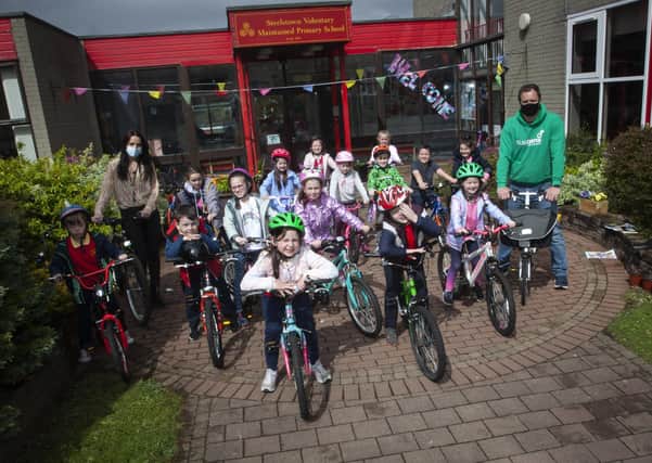 Steelstown Key Stage 1 pupils getting ready for their â€ ̃Cycle Skillsâ€TM session with Sustrans Richard Farrow on Wednesday last. Included is Miss Bronagh Lynch.