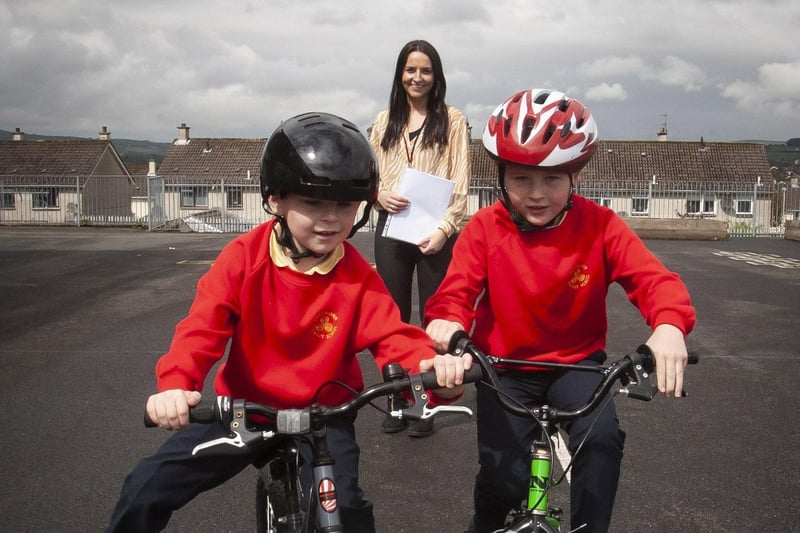 Steelstown PS teacher Miss Bronagh Lynch keeps a close eye on pupils Jack McFarland and Max McLaughlin as they enjoy practising their cycle skills. (Photos: Jim McCafferty Photography)