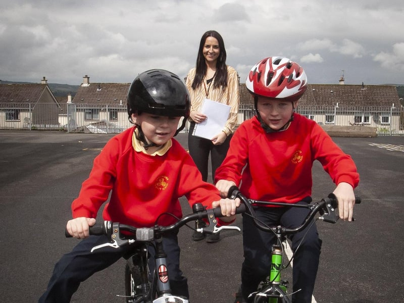 Steelstown PS teacher Miss Bronagh Lynch keeps a close eye on pupils Jack McFarland and Max McLaughlin as they enjoy practising their cycle skills. (Photos: Jim McCafferty Photography)