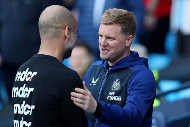 Manchester City manager Pep Guardiola shakes hands with Newcastle United head coach Eddie Howe.