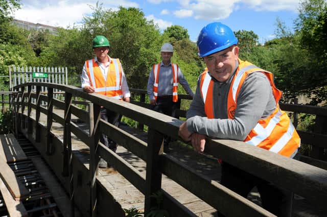 South Tyneside Council Cllr Ernest Gibson with ESH Civils contract manager Stephen McClean and project manager Steve Marshall, at the damaged Mill Dene footbridge over the River Don which is to be replaced.