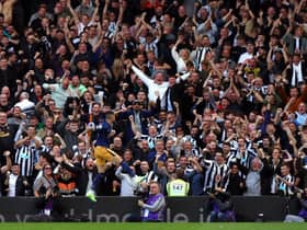 Newcastle United fans celebrate Miguel Almiron's second goal at Craven Cottage.