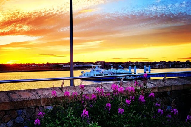 A picturesque view of the ferry and ferry landing. Look at those golden skies!